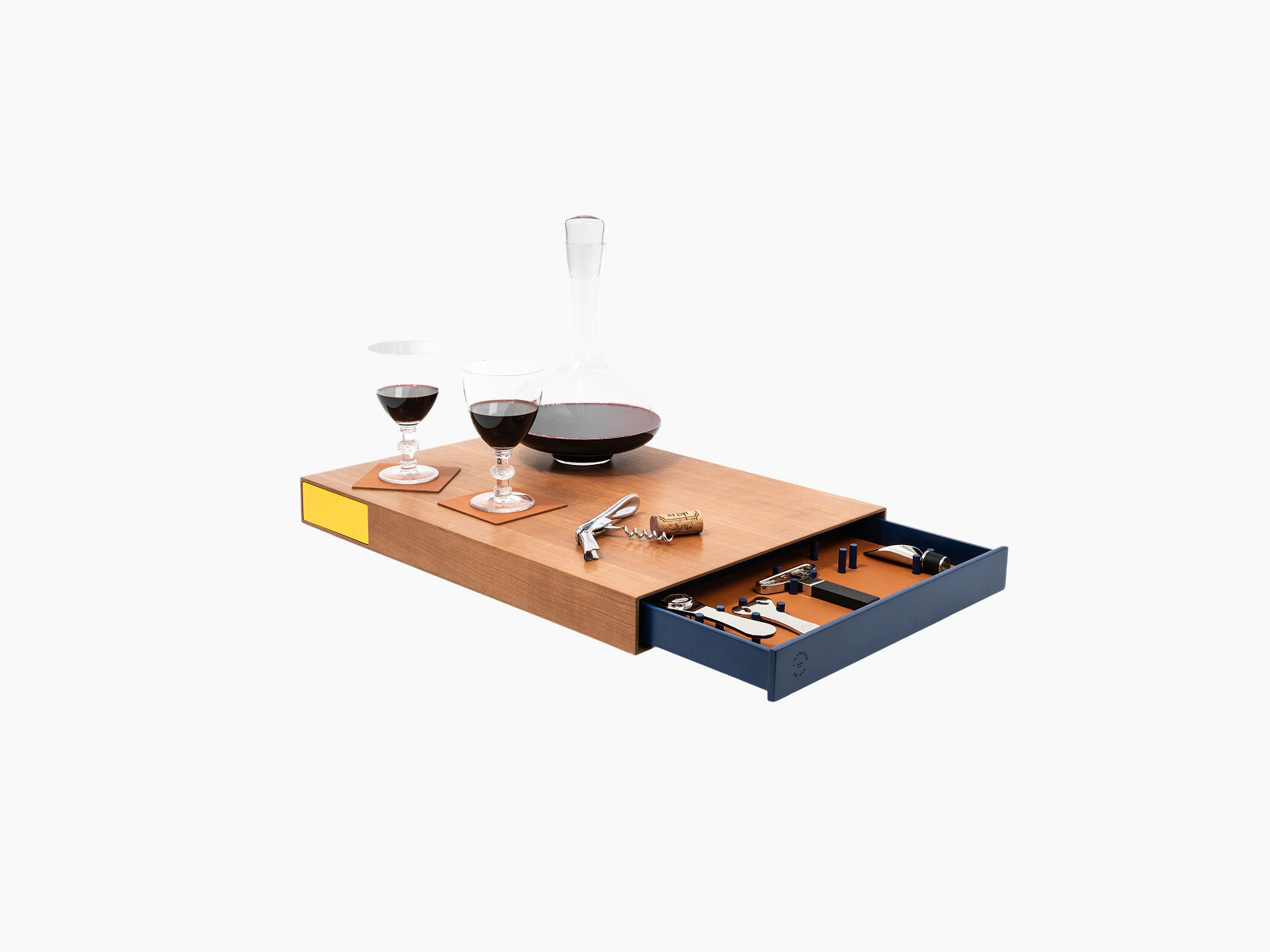 Le Plateau with two wine glasses and a decanter on the wooden tray, blue tool drawer opened with corkscrew and accessories.