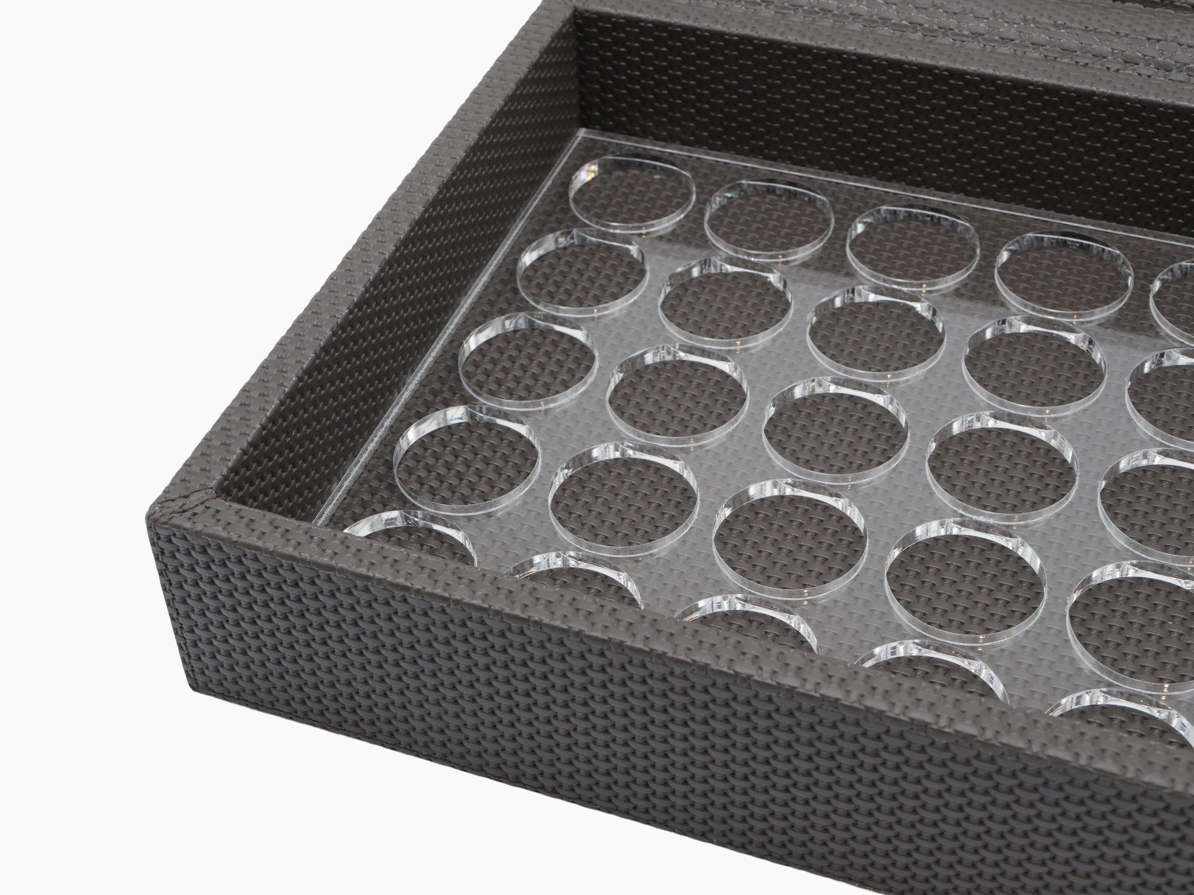Close up of Luna Box interior with a plexiglass tray and circular capsule slots.