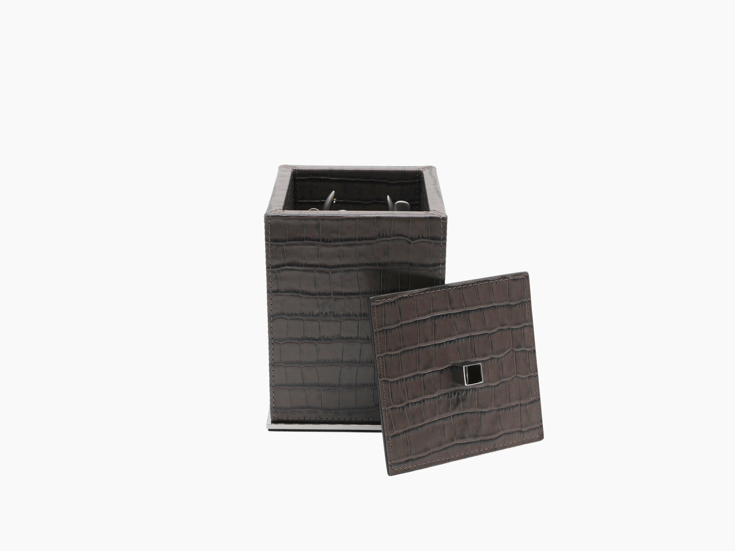 Crocodile pattern leather manicure box with square opening and a separate lid resting beside it.