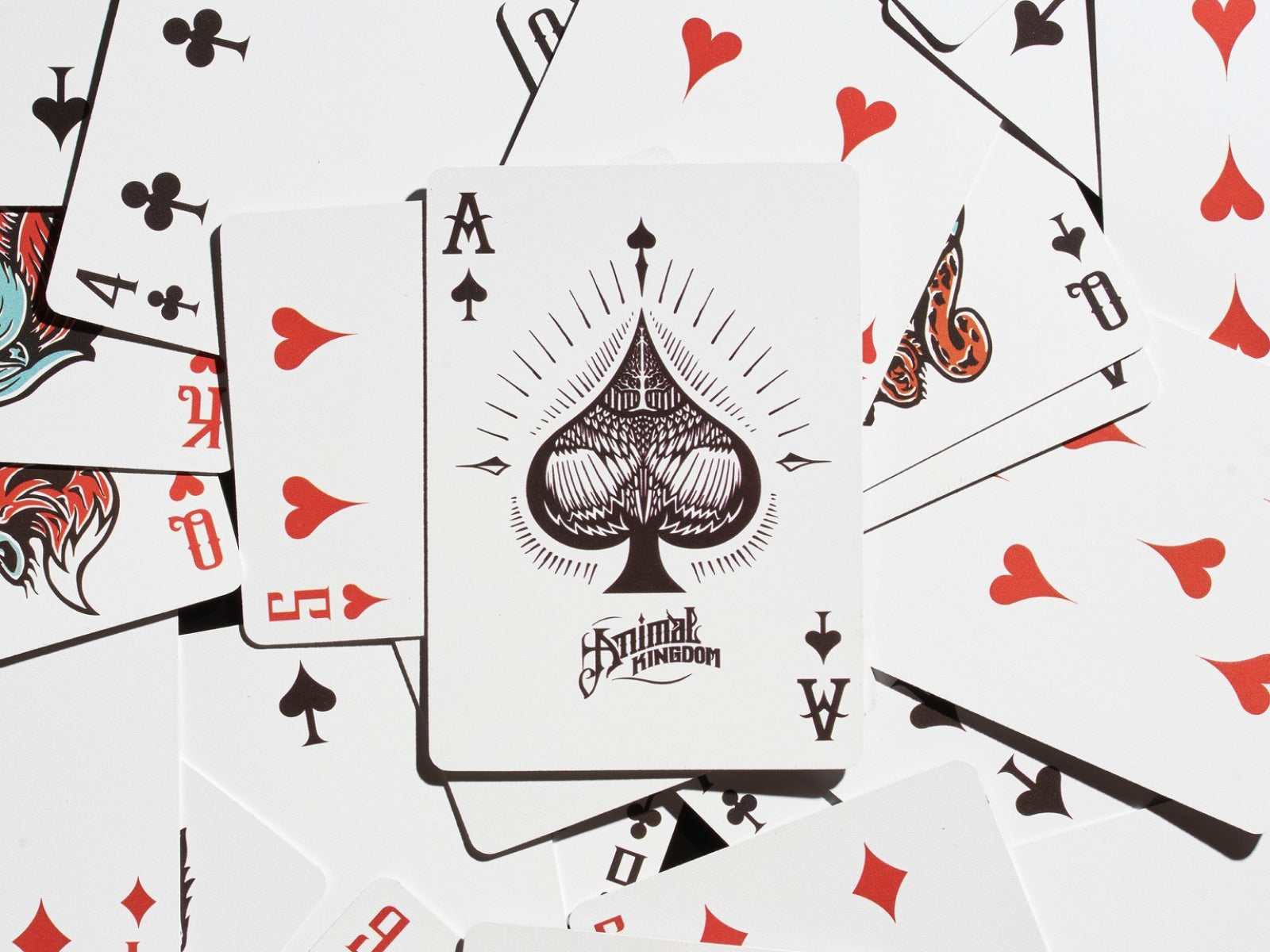 Close-up of Animal Kingdom Playing Cards featuring a bold Ace of Spades and scattered heart cards.