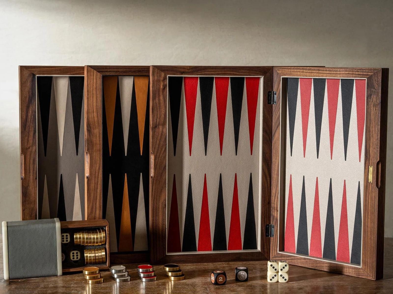 Premium walnut backgammon set in a multi panel case opened to reveal red black and tan triangular boards and dice