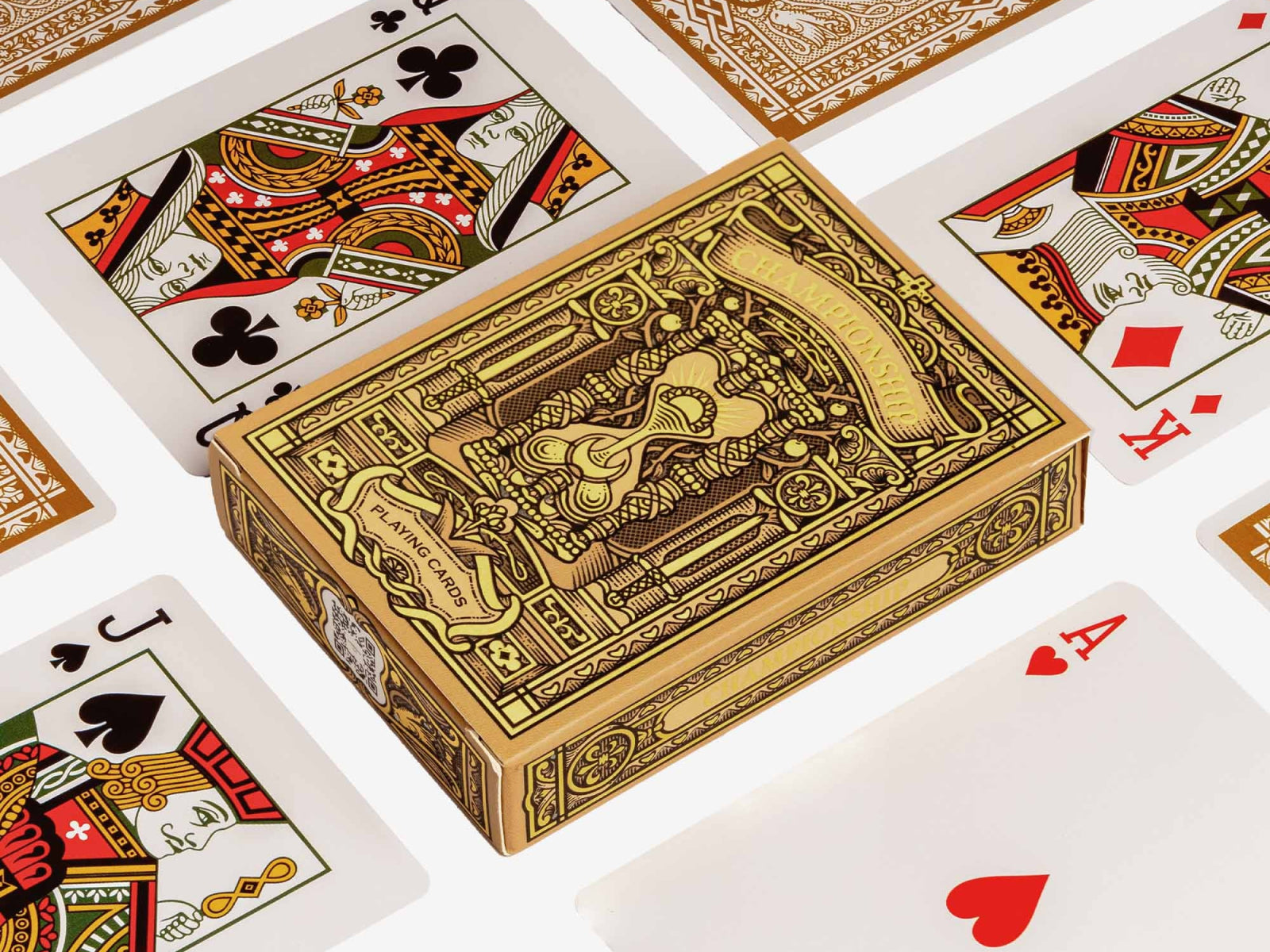 Gold ornate Championship playing cards box surrounded by colorful playing cards