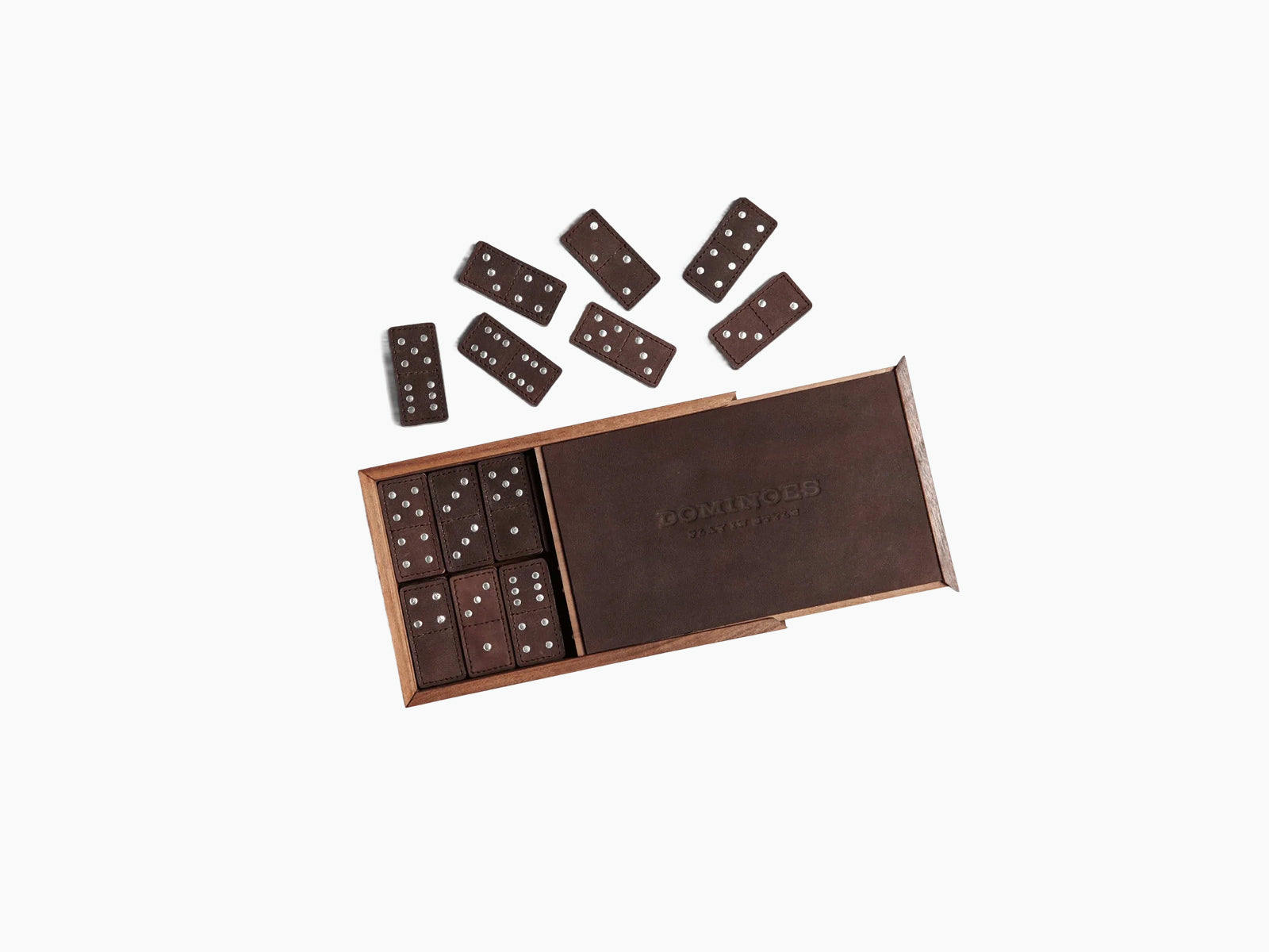 Brown leather domino set inside a wooden box with lid closed and DOMINOES embossed on the lid