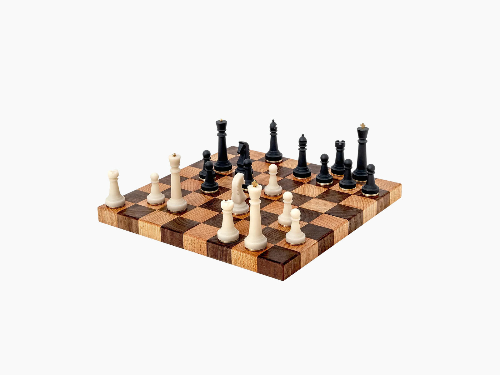 Nomad portable chess set on a walnut and beech modular board with white and black pieces ready to play.