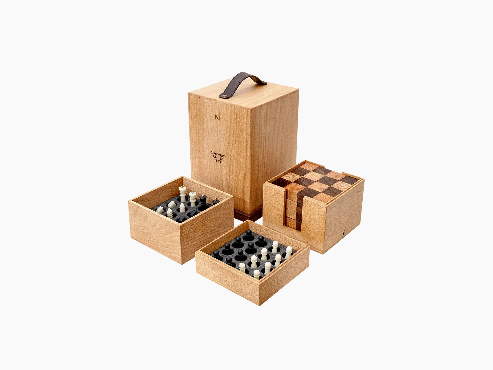 Tall wooden travel case with leather handle surrounded by three companion boxes for Nomad chess pieces and board.