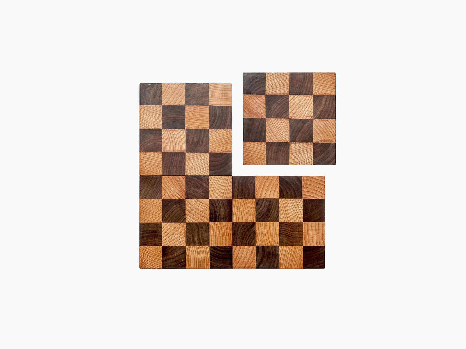 Nomad modular chess board in walnut and beech wood shown as two of four disassembled pieces for travel and display
