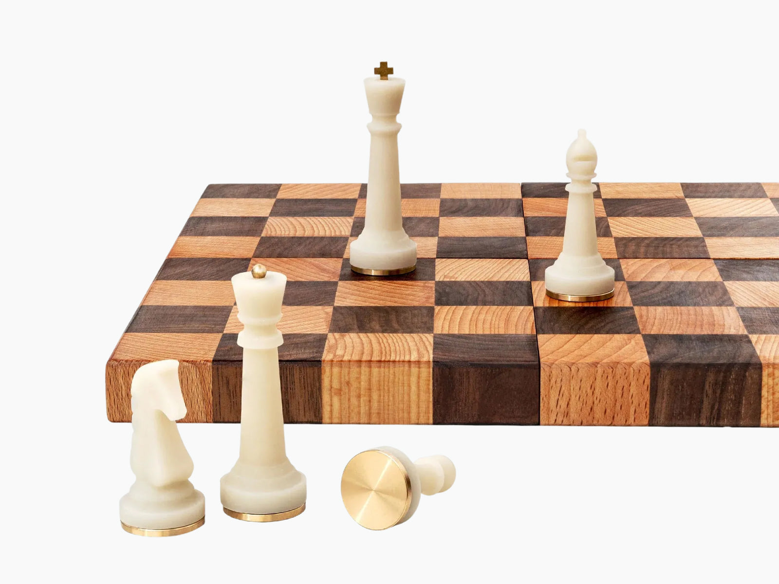 Close up of white Nomad pieces on a two tone board with a tall king and nearby knight