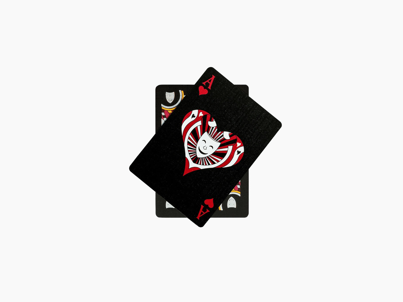 Three overlapping Ritual Masks playing cards with black textured fronts and a bold red heart on the top card.