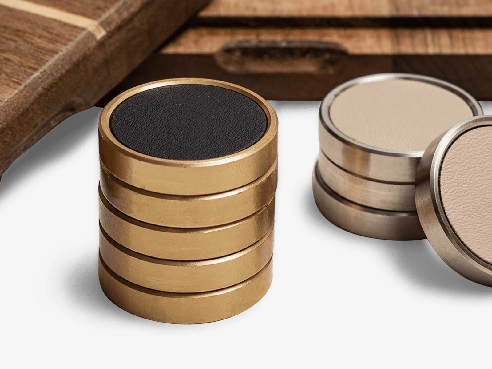 Close-up of a wooden Tic Tac Toe set with brass and leather tokens arranged on a 3x3 grid.