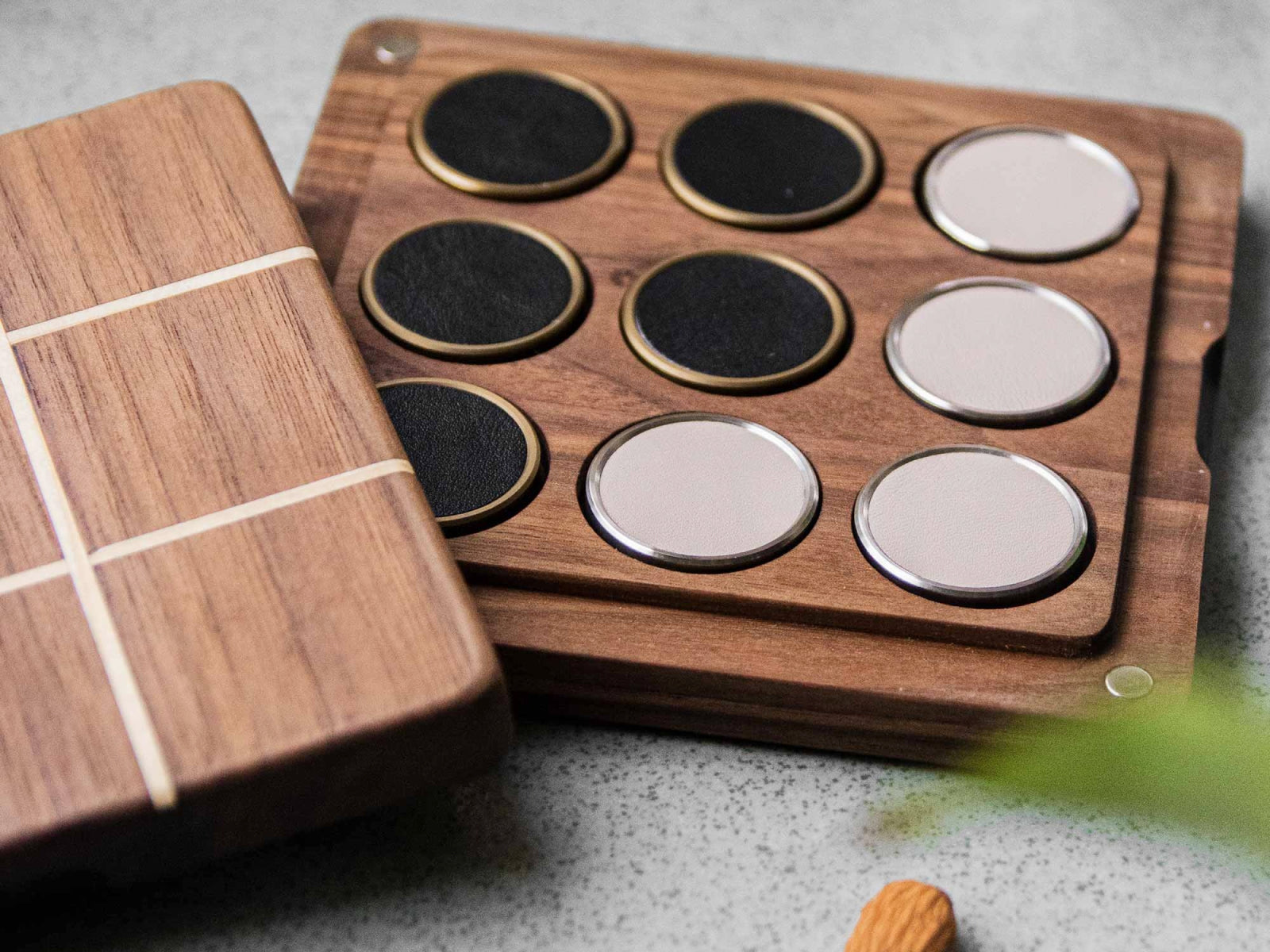 Open walnut and pine Tic Tac Toe set displaying round leather tokens and a lid that converts into the elegant box