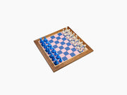 Bespoke Tournament Chess Set on a wooden frame board with pink and blue squares, blue and white pieces arranged for play.