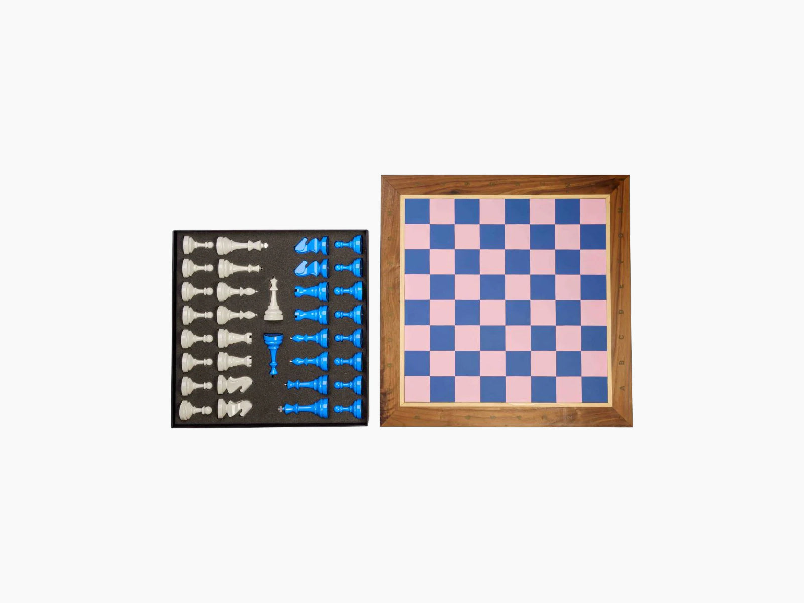 Two tone Bespoke Tournament Chess Set with white and blue pieces in a foam-lined case beside a brown and beige framed chessboard.