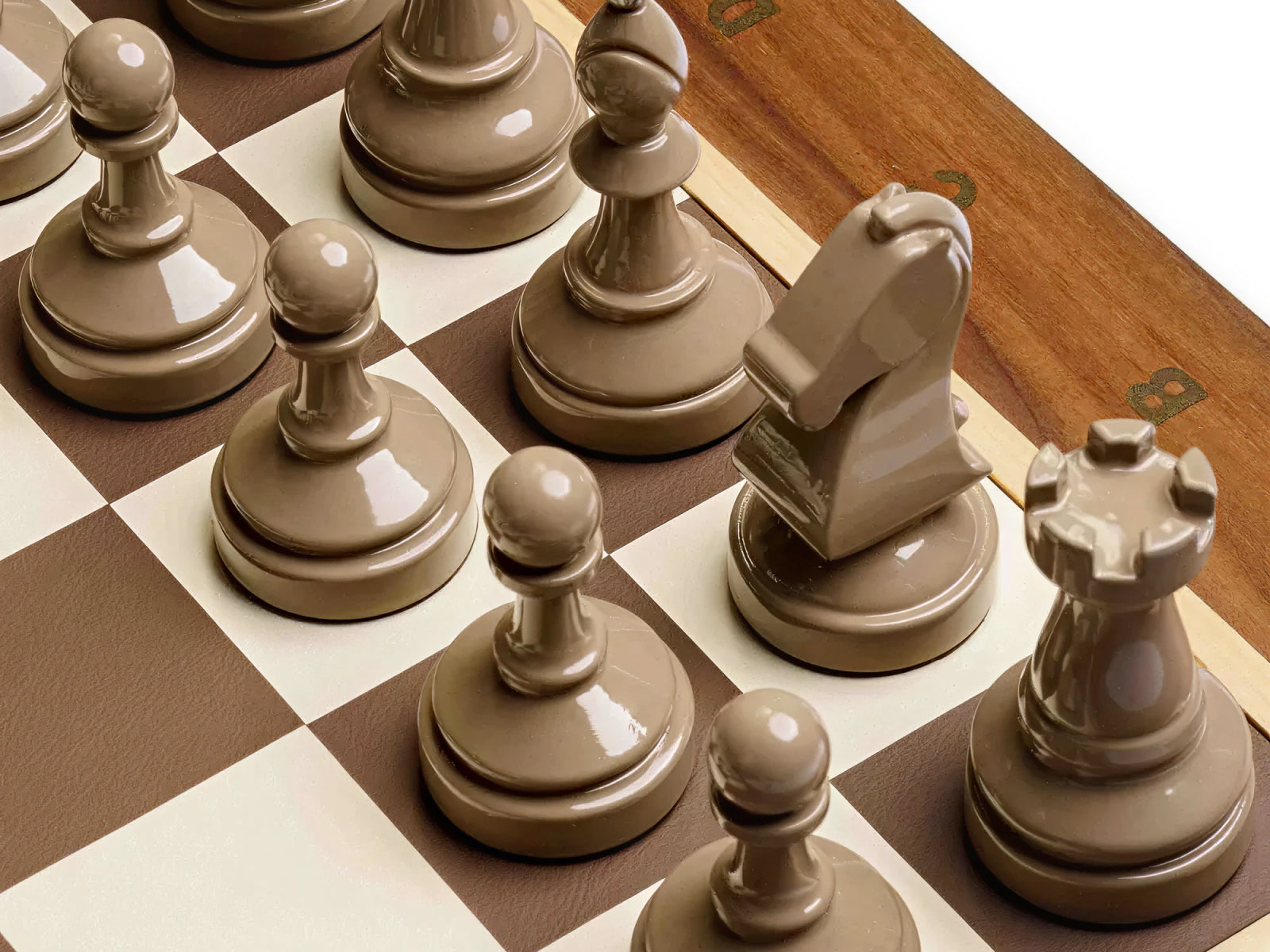 Close up of taupe chess pieces on a brown and ivory checkered board from the Bespoke Tournament Chess Set