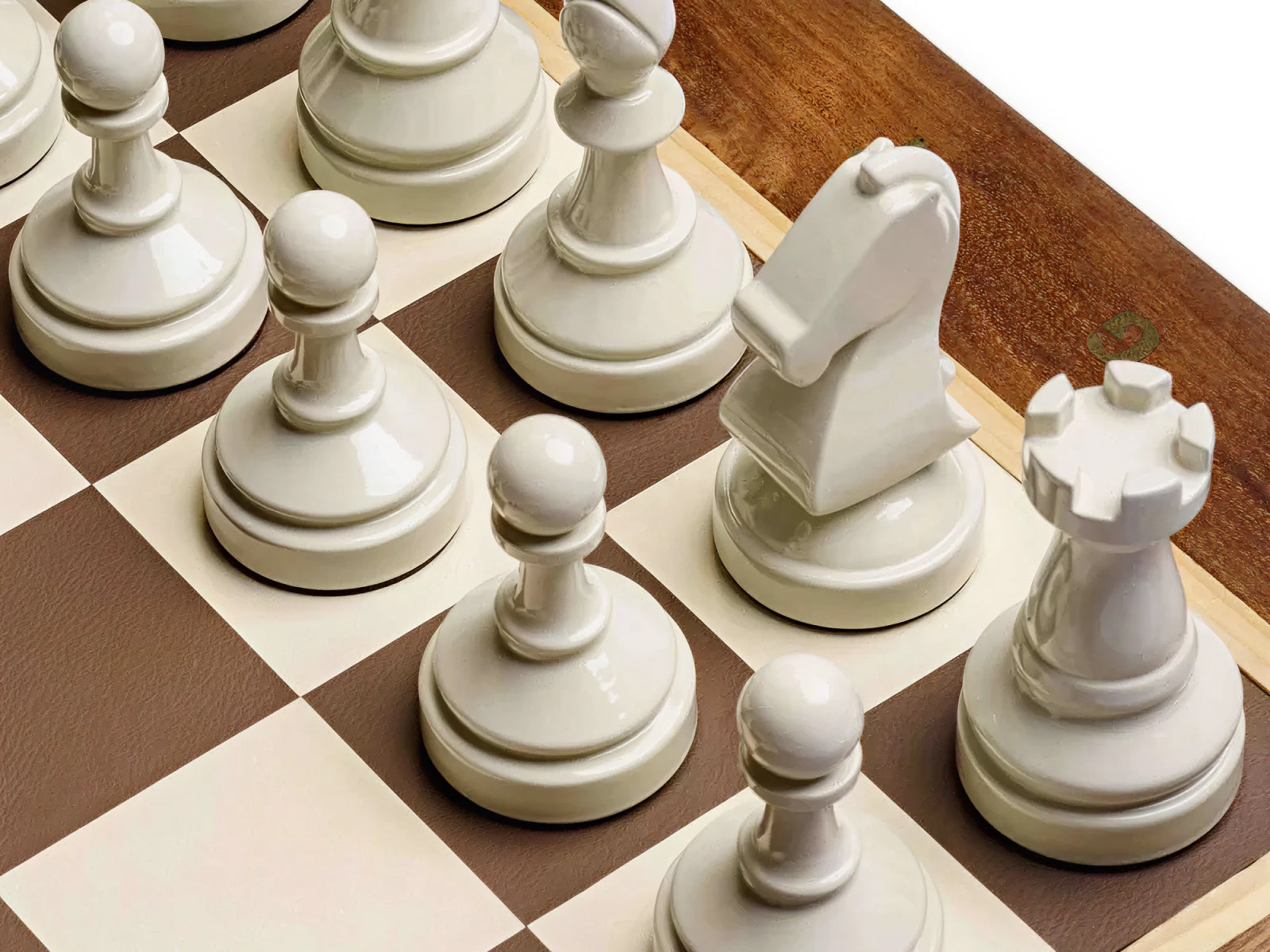 Cream colored chess pieces on a light and dark checkered board from the Bespoke Tournament Chess Set