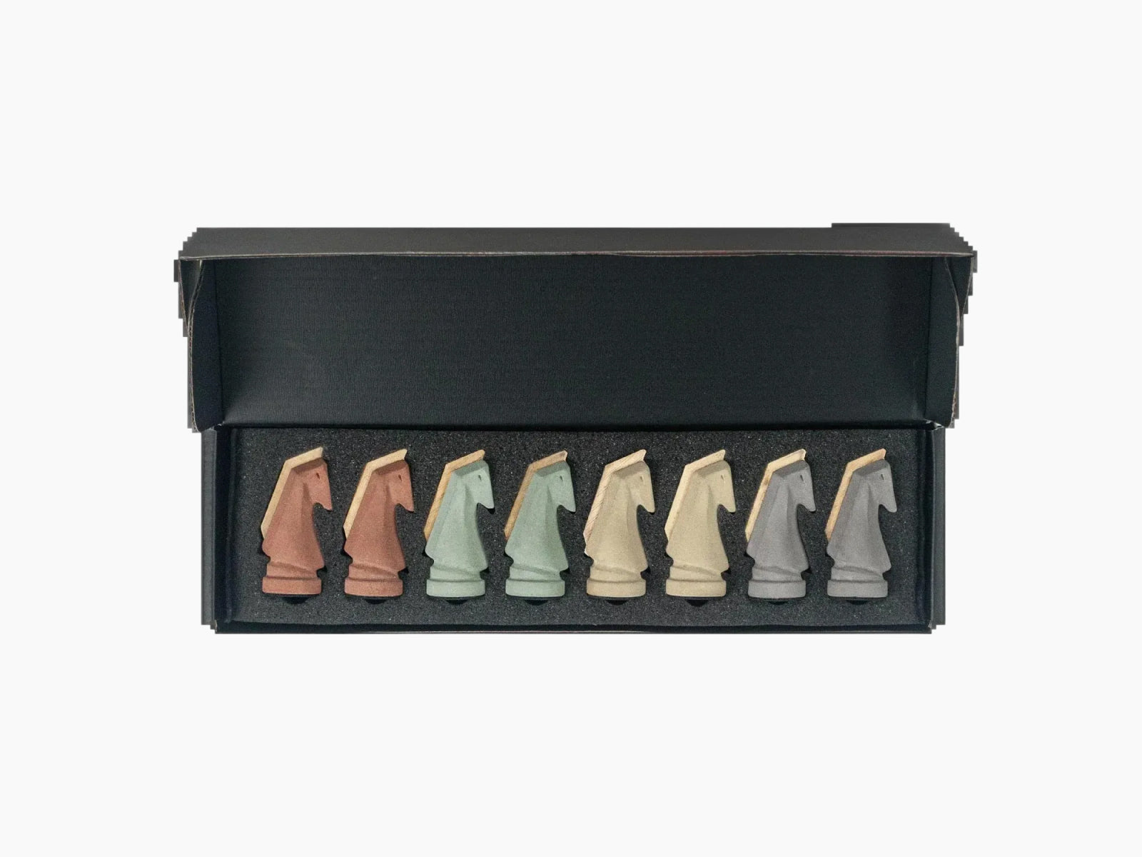 Trojan Horse Race Ludo set in a black open box with nine earth toned cement horse pieces arranged in a row