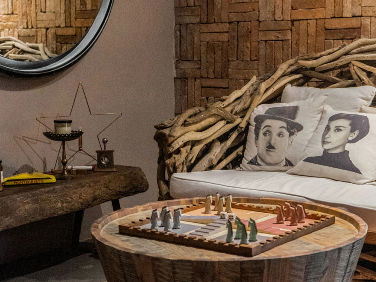 Trojan Horse Race Ludo on a round wooden stump table in a cozy rustic living room with pillows and driftwood decor