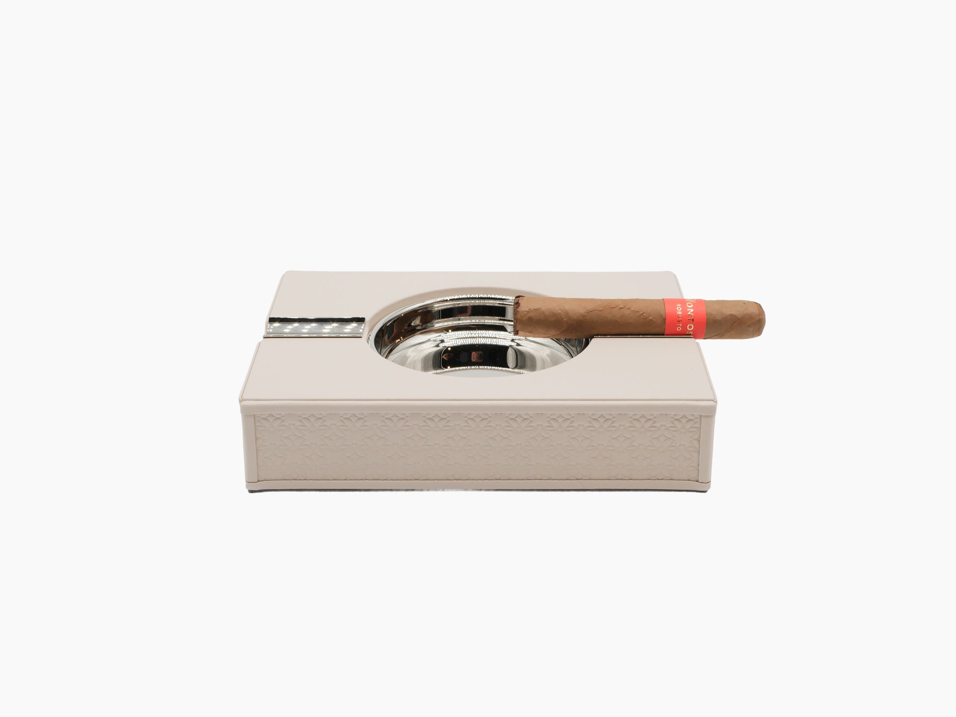 Elie Saab Monogram Cigar Set in pale leather with chrome ashtray and lighter, cigar resting on top.