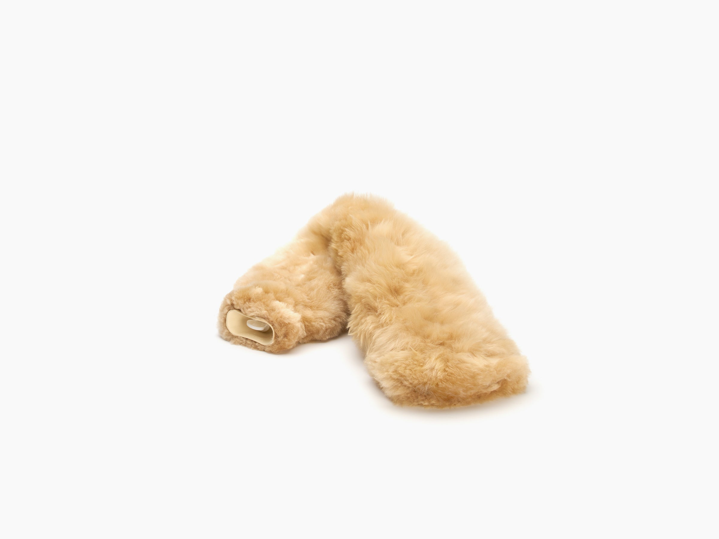 Beige plush fur neck hot water bottle resting on a white background