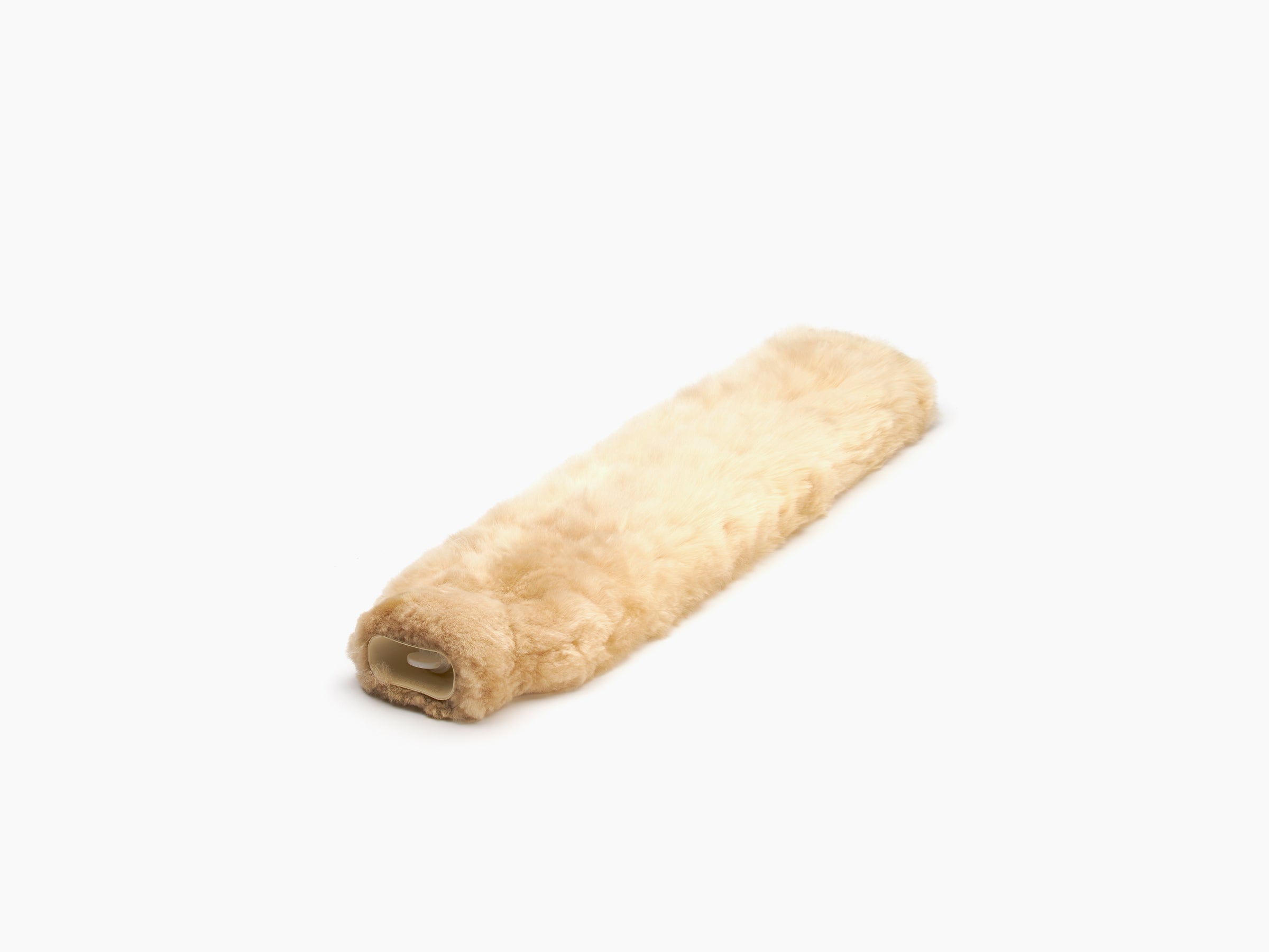 Beige plush fur neck hot water bottle beside a cream drawstring bag with a logo