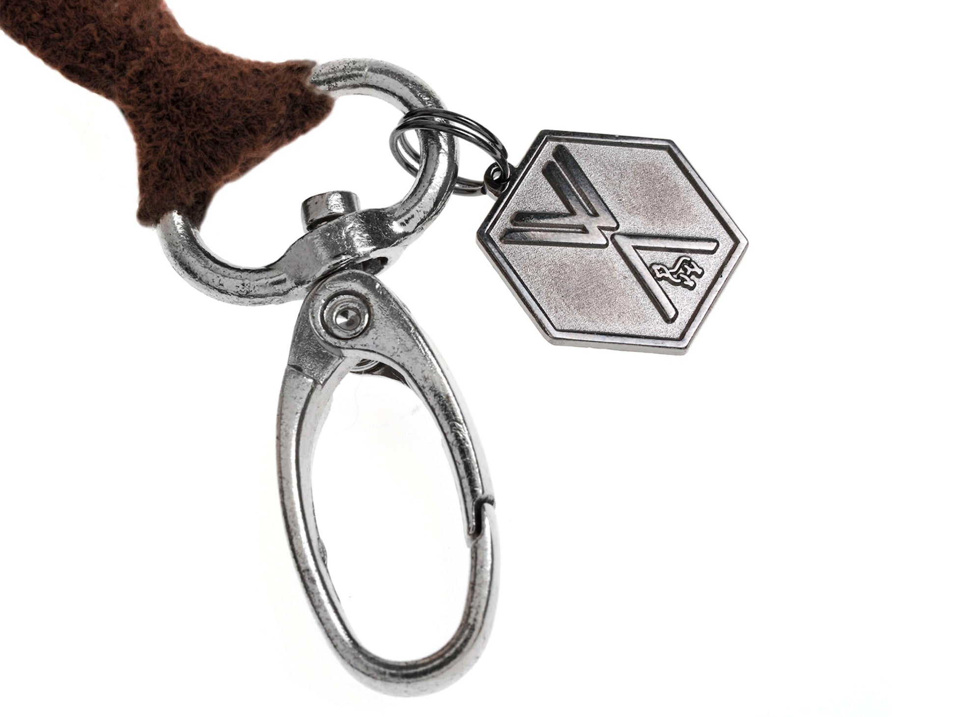 Brown fluffy Pompom CLAVE keychain with silver hardware and hex charm.