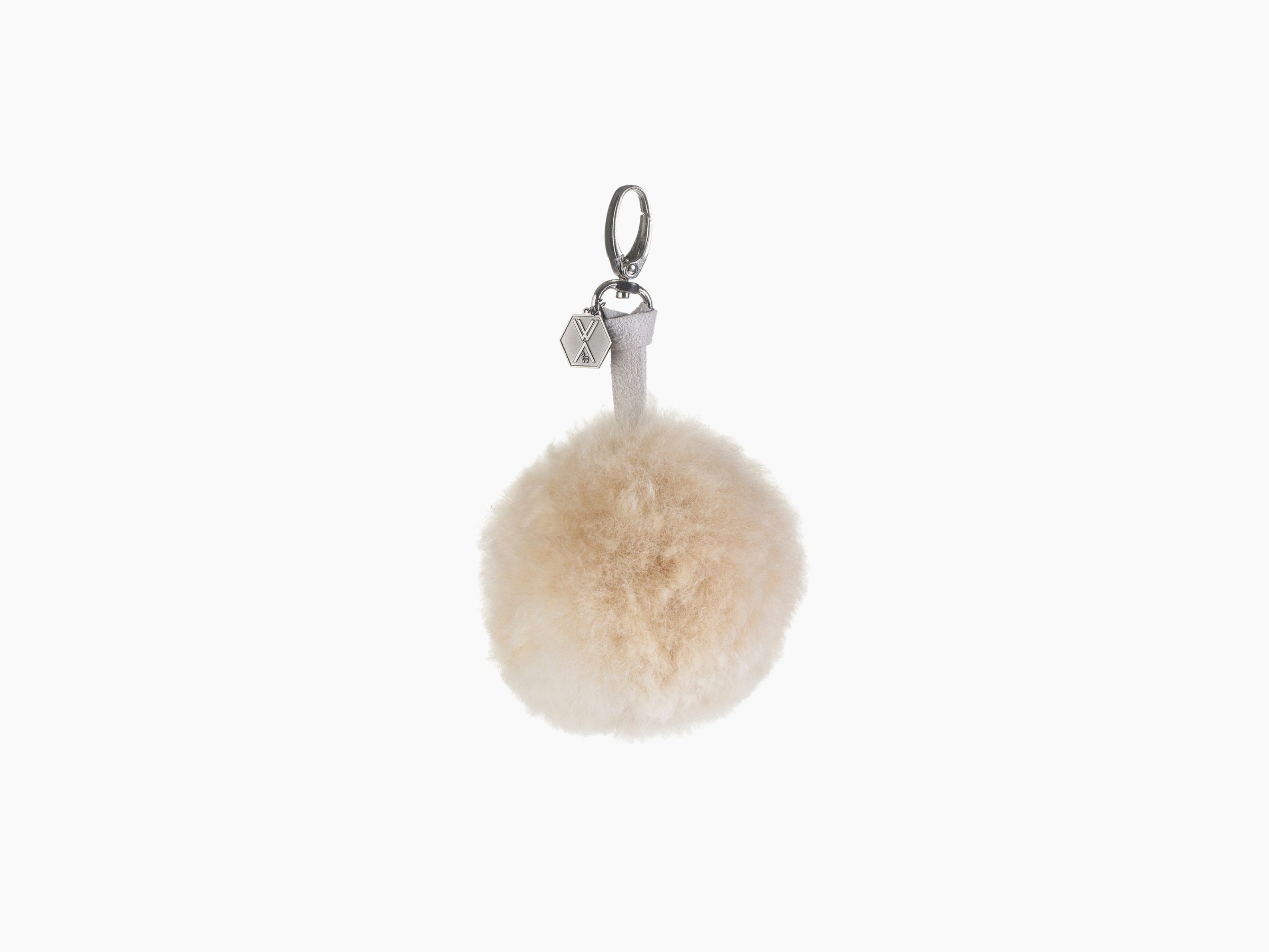 Cream pompom CLAVE keychain with a light gray strap and silver hardware, hex charm.