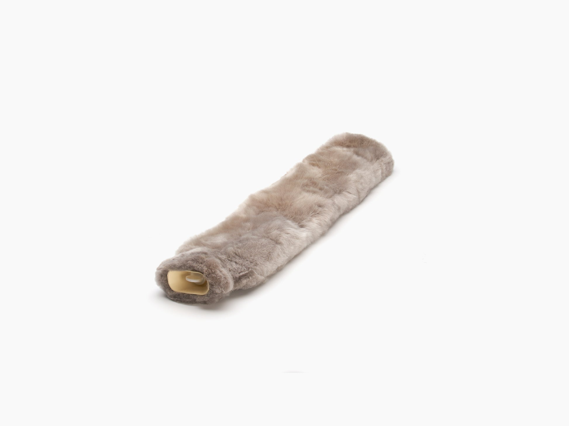 Long plush neck hot water bottle with alpaca cover showing beige end cap laid diagonally
