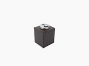 Nereo handwoven leather table lighter with a round chrome top on a dark brown leather cube