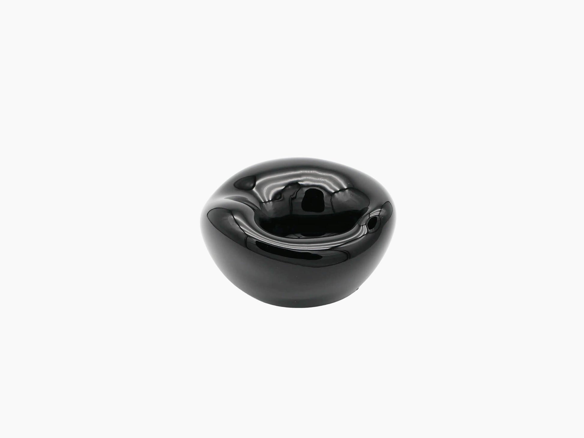 Small obsidian black hand blown glass vessel with a glossy rounded shape and inner concave opening.