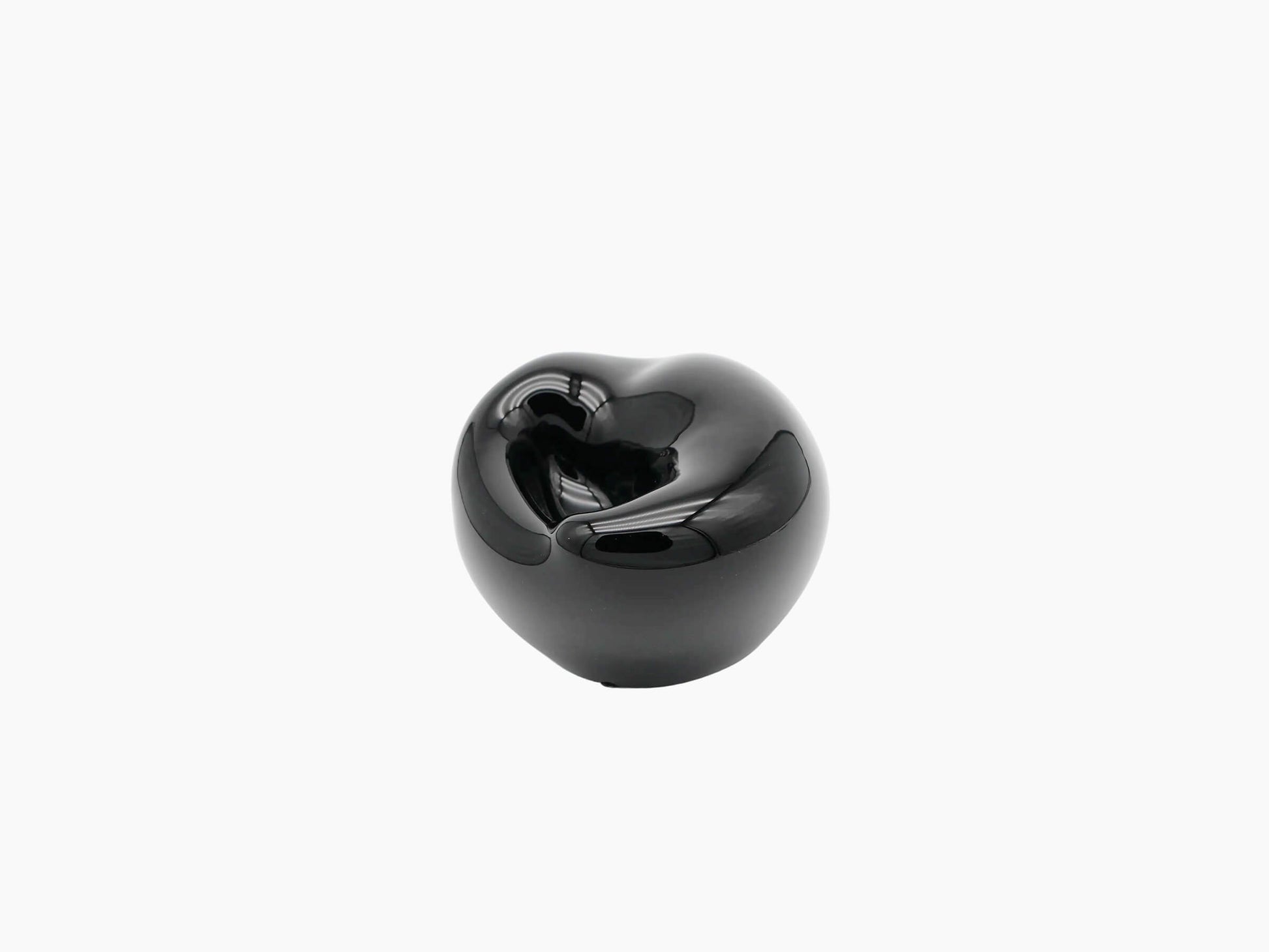Small obsidian black hand blown glass vessel shown from the side with a compact rounded form and high gloss.
