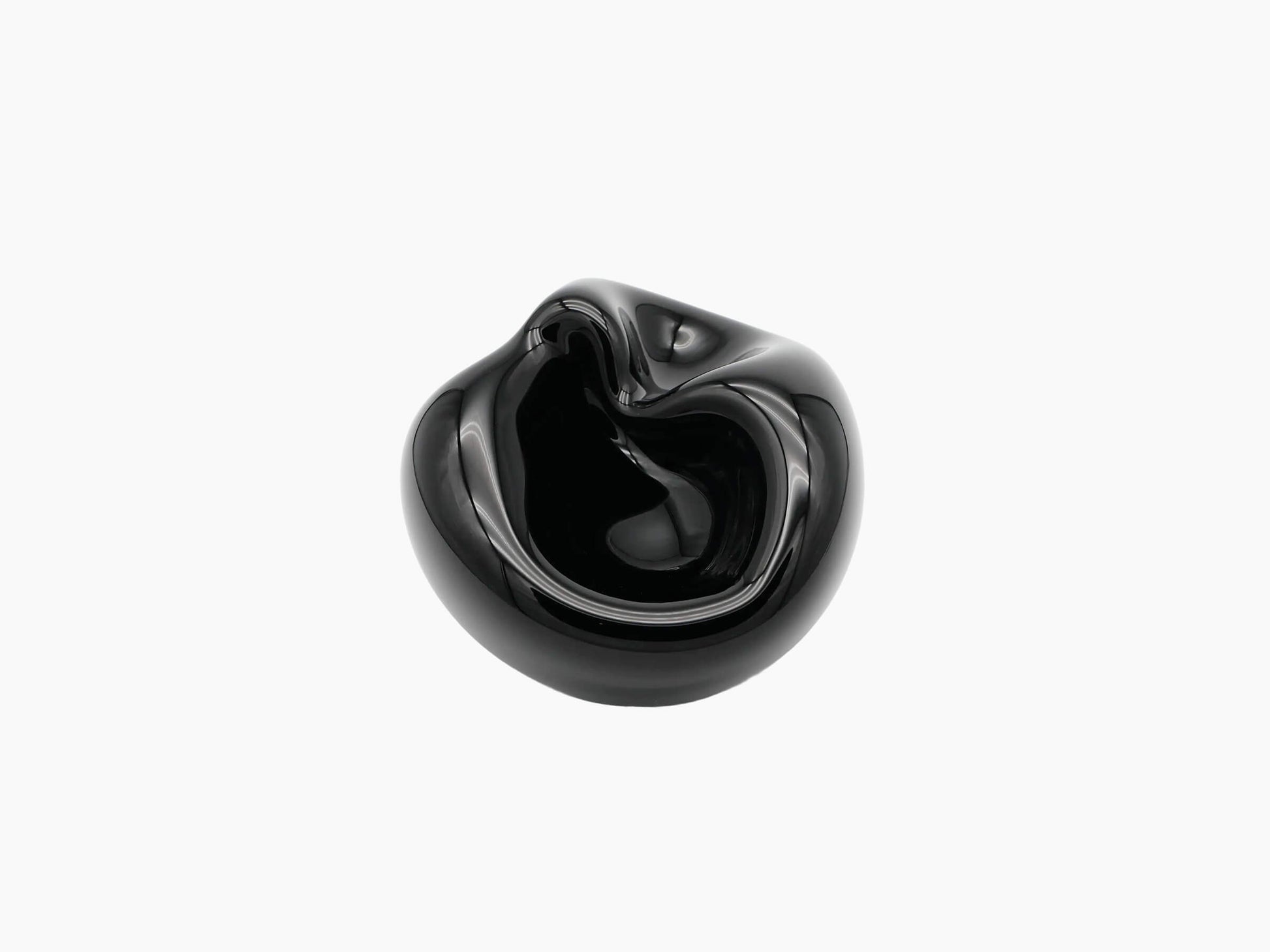 Large obsidian black glass vessel with flowing sculptural curves and a dark hollow interior.