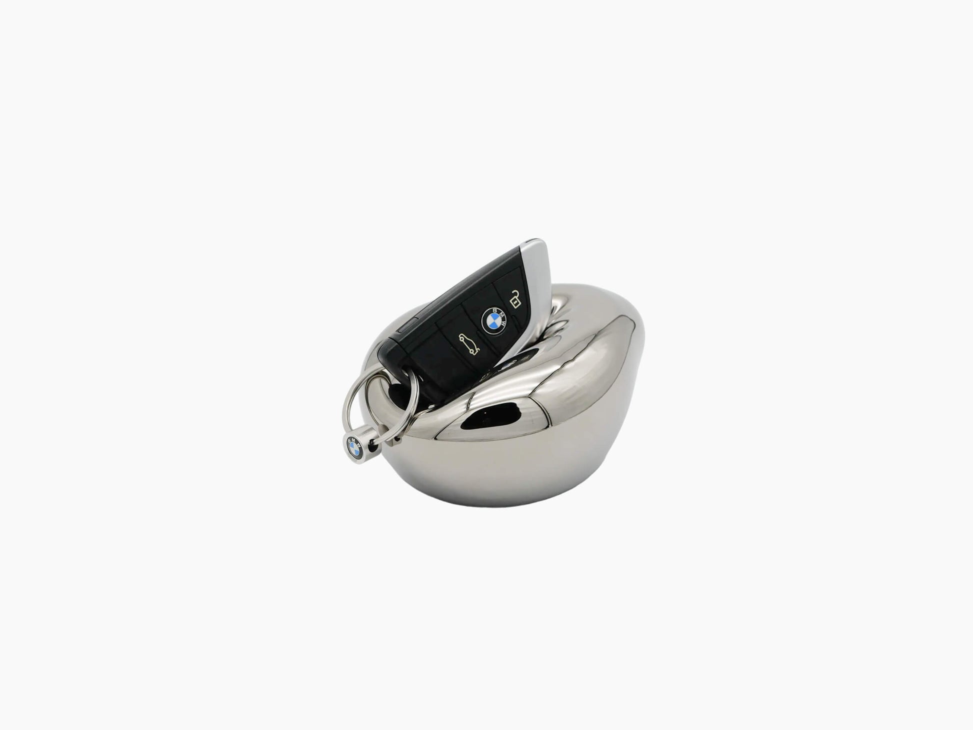 Vessel Small Mercury Silver glass sculpture with a smooth rounded body and a key fob resting on its top.