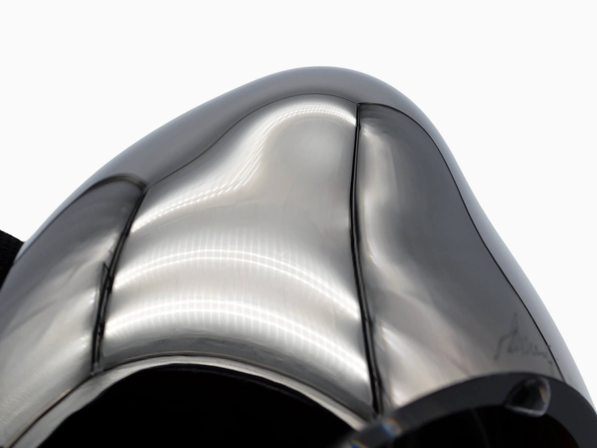 Close-up of Vessel Small Mercury Silver glass sculpture with a curved mirrored surface and reflections.