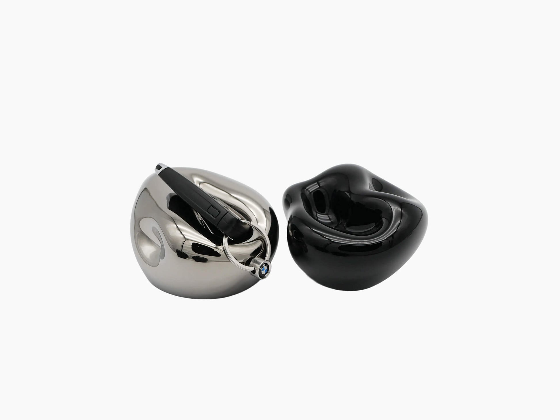 Mercury Silver and black vessels displayed together with a BMW car key ring