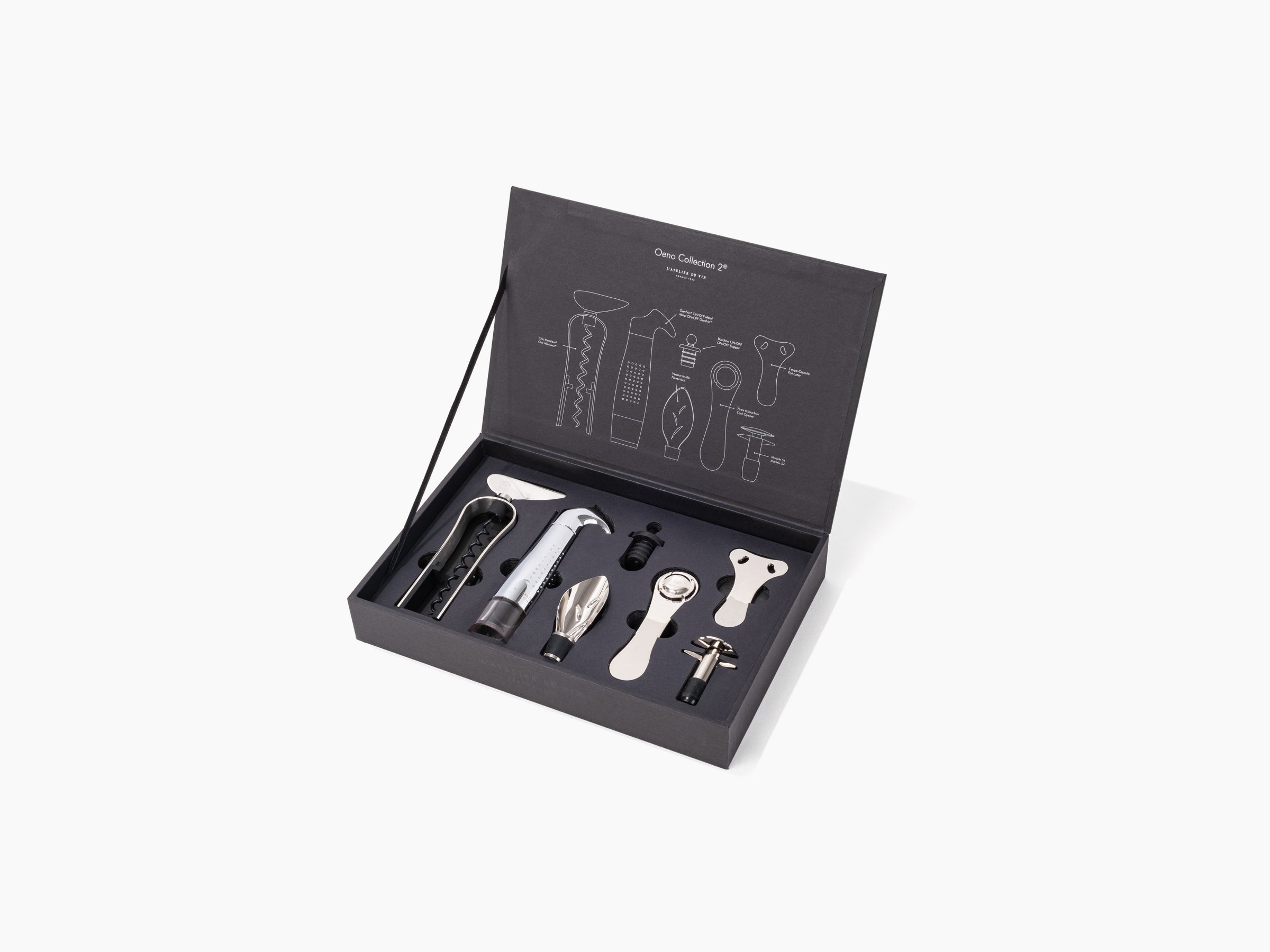 Open matte black wooden box from the Oeno Collection 2 showing corkscrew, pourer, stopper and other wine tools.
