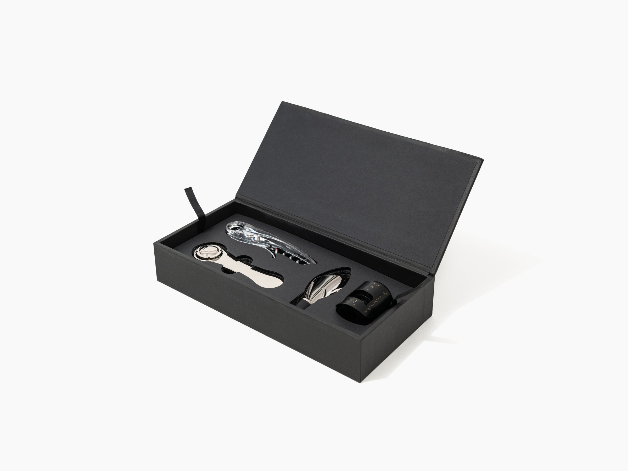 Open black box showing polished stainless steel wine tools nestled in foam insert