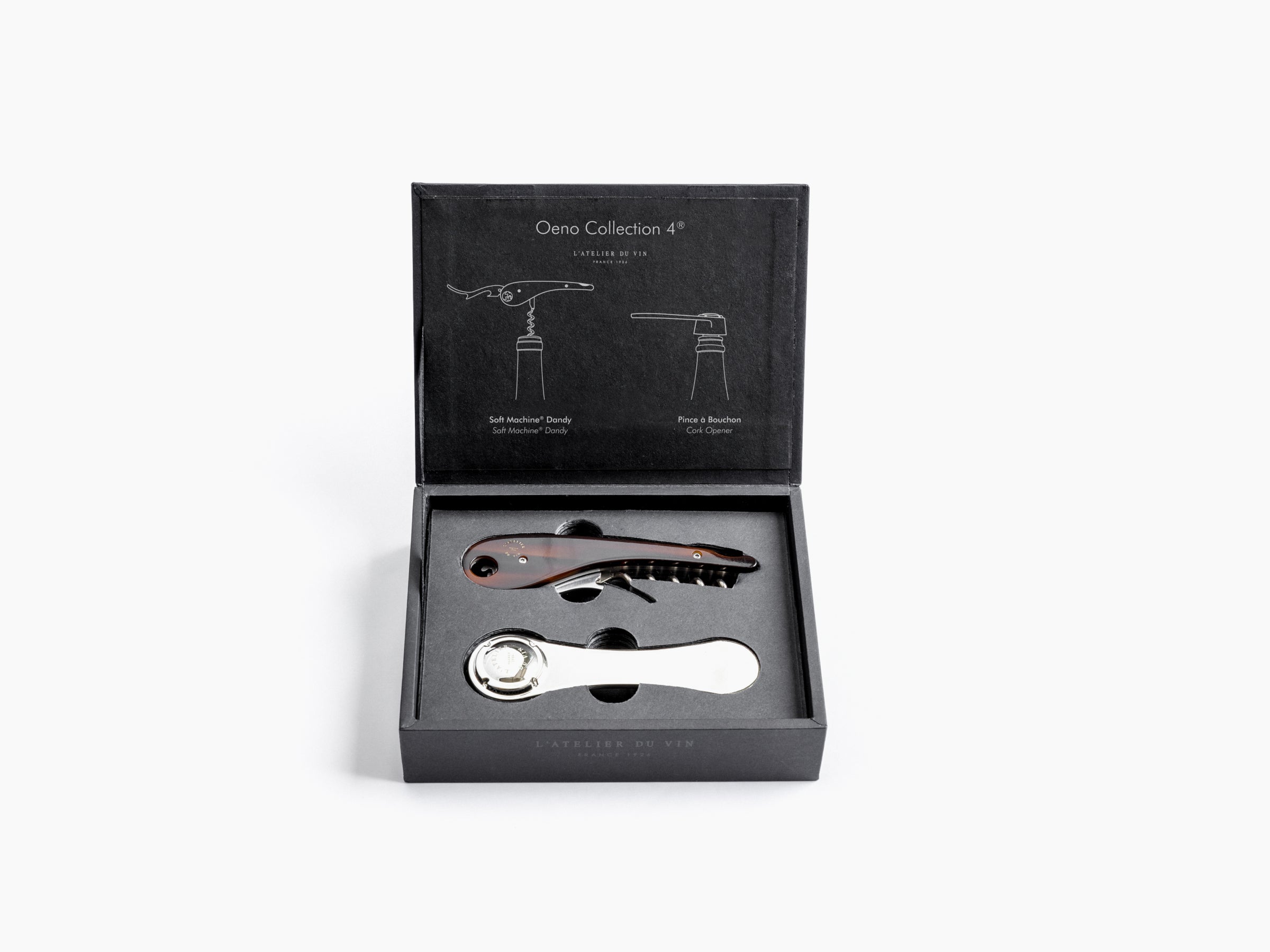 Open matte black box reveals two wine opening tools nestled in foam a wood handled corkscrew and a polished lever opener