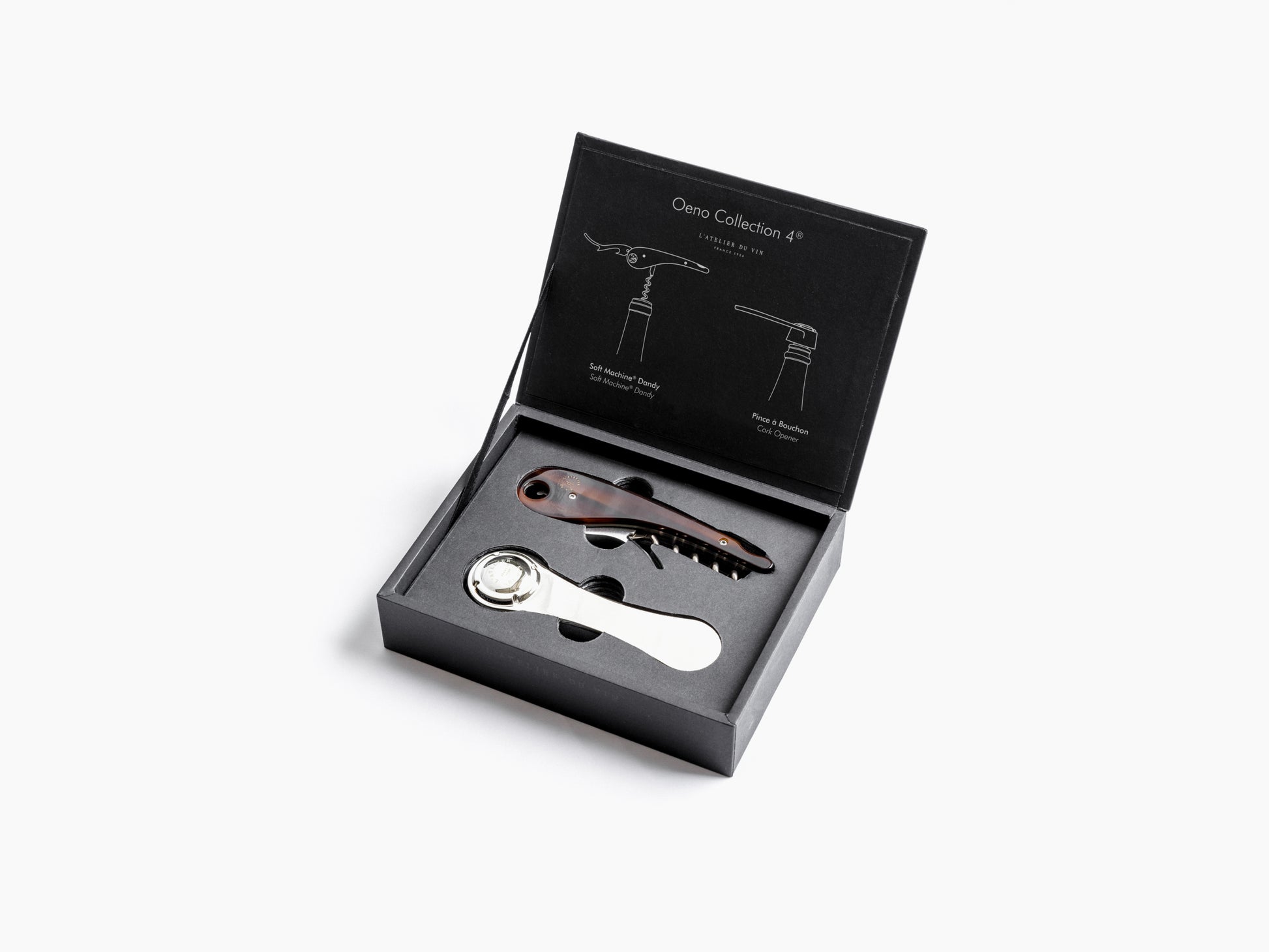 Oeno Collection 4 box open to show two wine opening tools in foam with champagne flutes visible in background