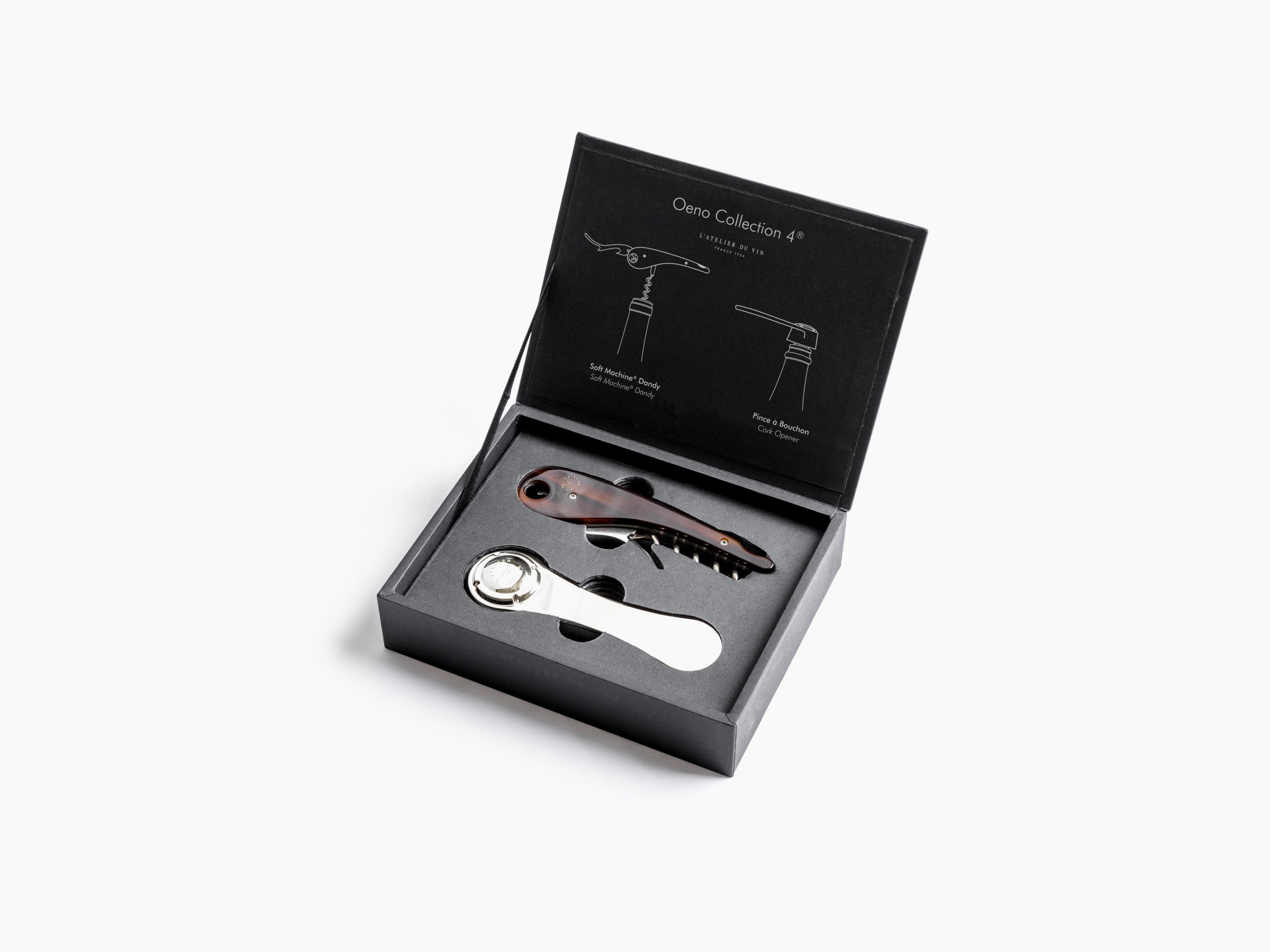 Oeno Collection 4 box open to show two wine opening tools in foam with champagne flutes visible in background