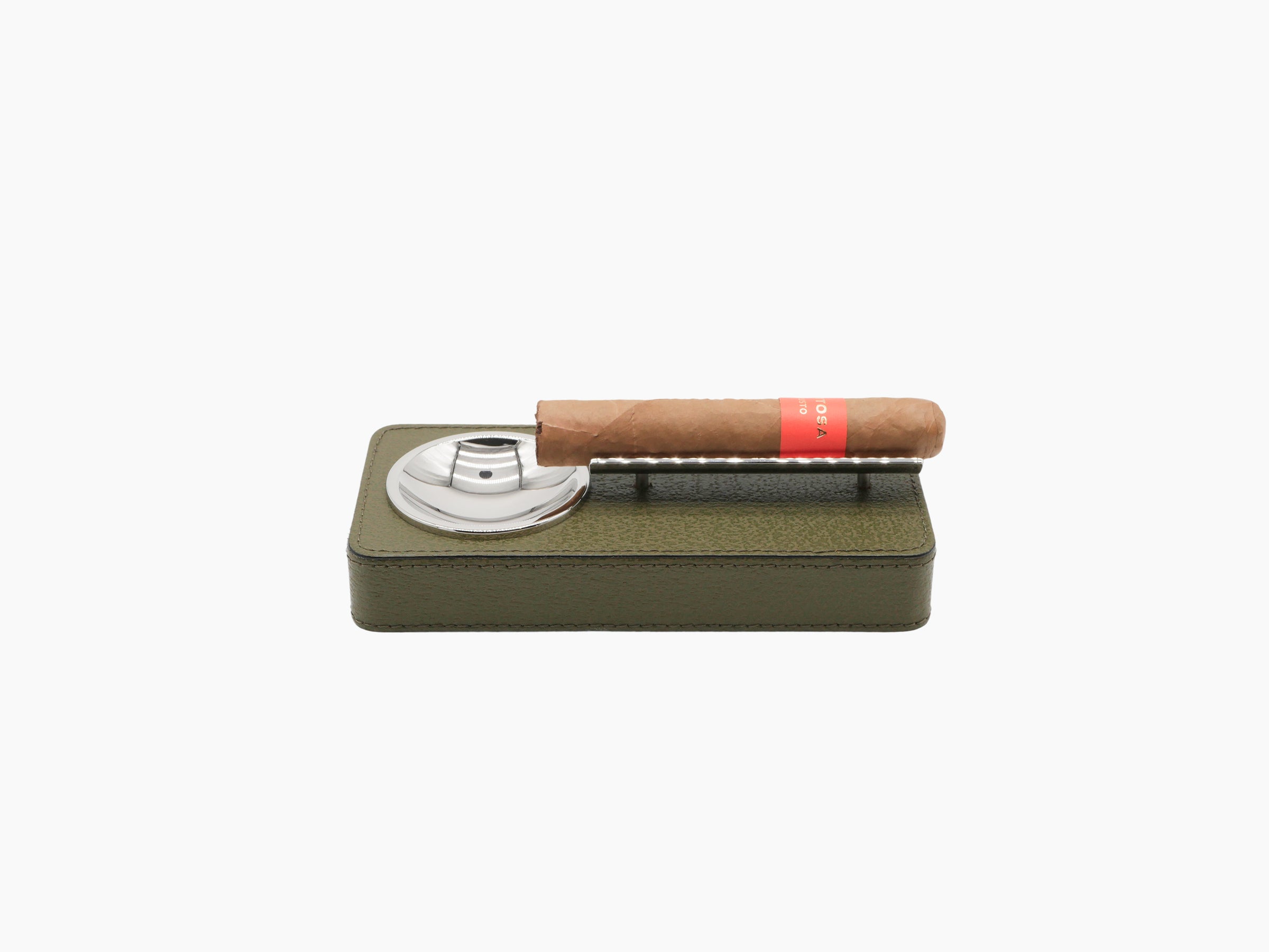 Olive green leather ashtray with cigar resting on the bar; matching cylindrical humidor shown nearby.