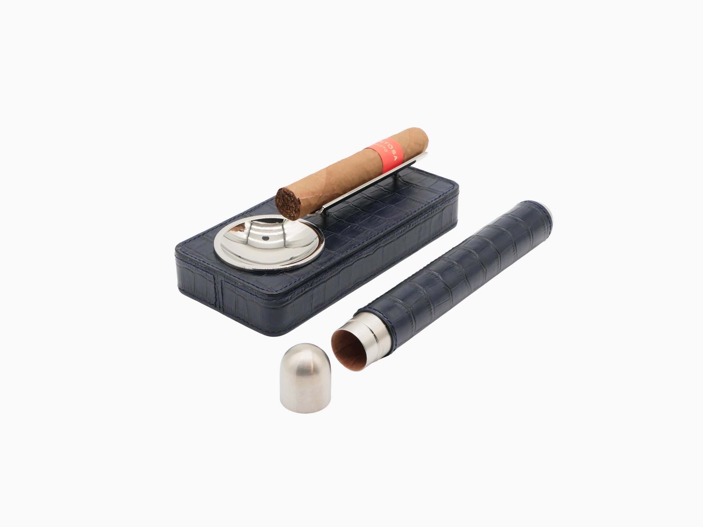 Olive green leather Pinar ashtray with chrome ash bowl and cigar resting on the bar beside a matching cylindrical humidor.