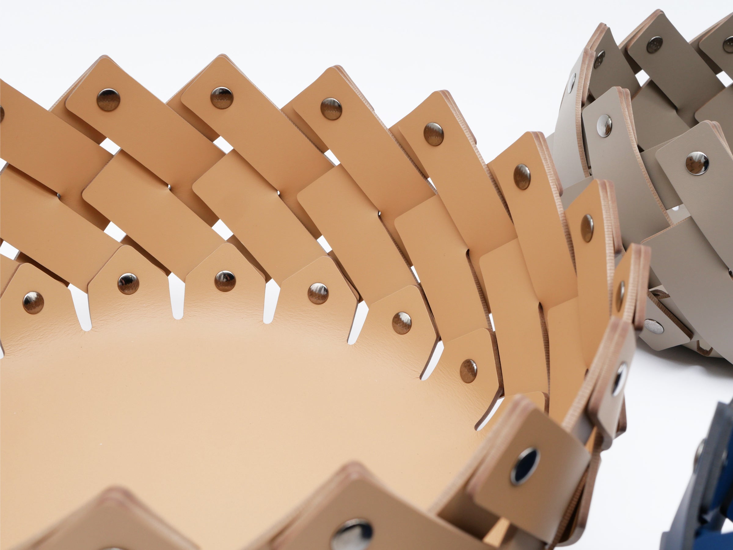 Close-up of Almeria Round Emptypockets basket revealing interwoven leather strips and chrome fittings in warm tan