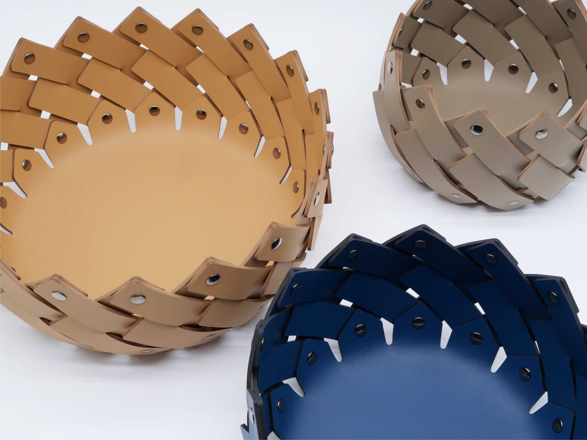 Almeria Round Emptypockets leather baskets in tan, taupe and navy with sculptural woven edges