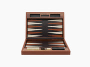 Open backgammon set in warm Canaletto walnut with leather playing surface and scattered pieces.