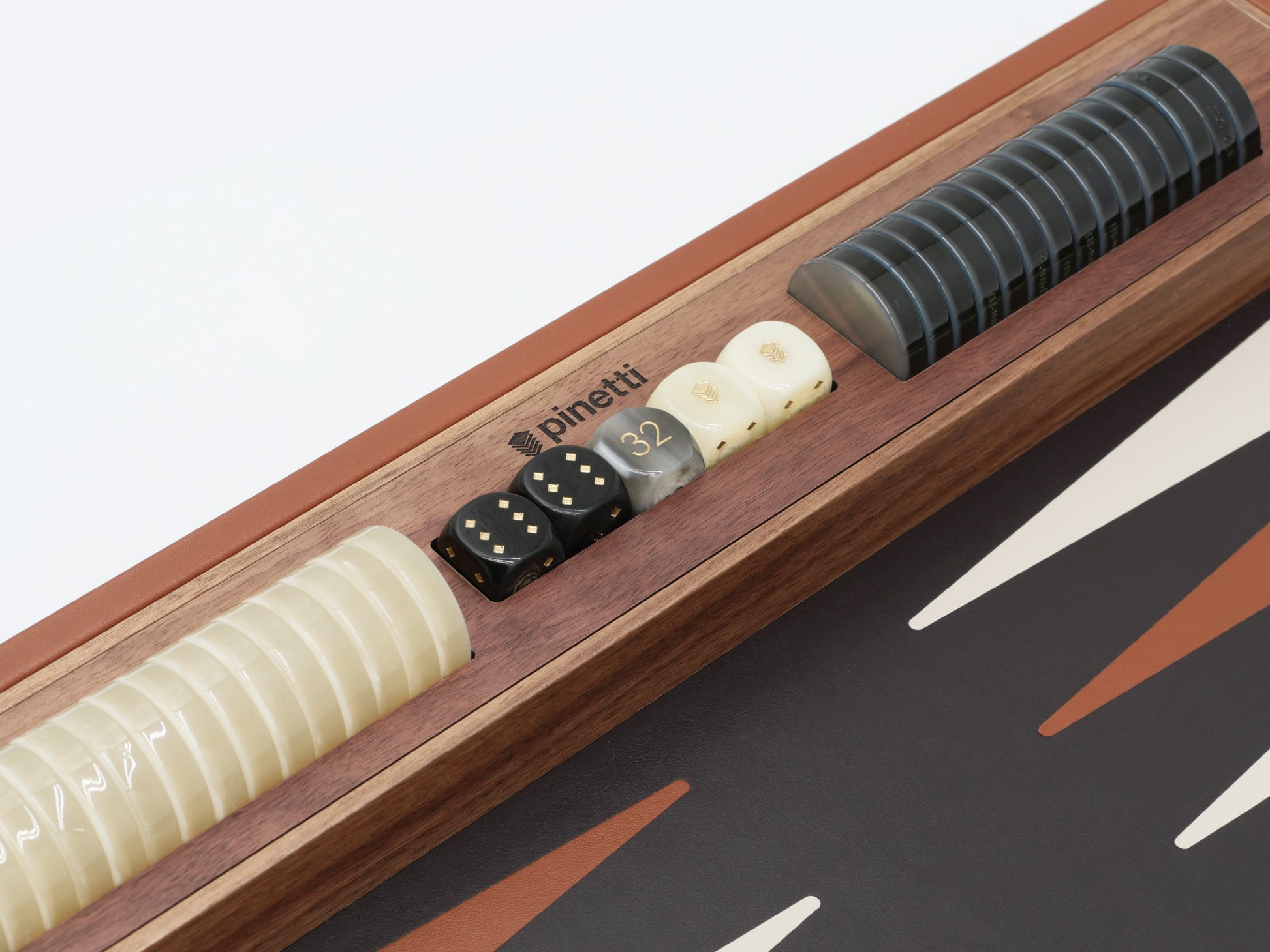 Backgammon edge with stacked dice towers and white checkers on a walnut board.