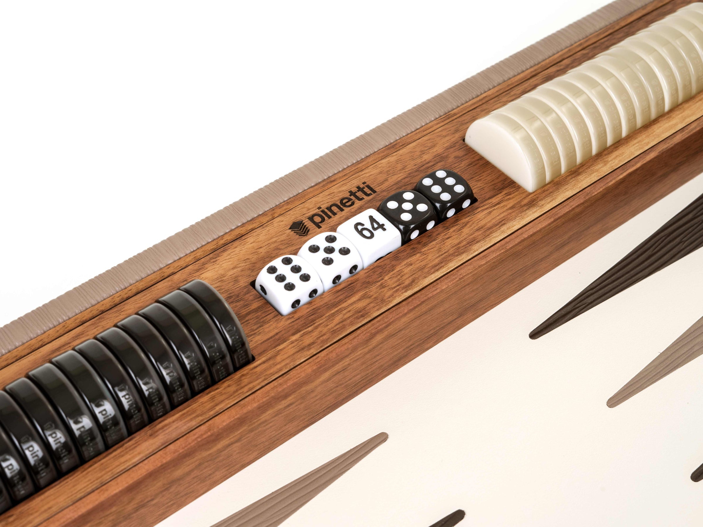 White numeric dice alongside ivory checkers on a walnut backgammon board.