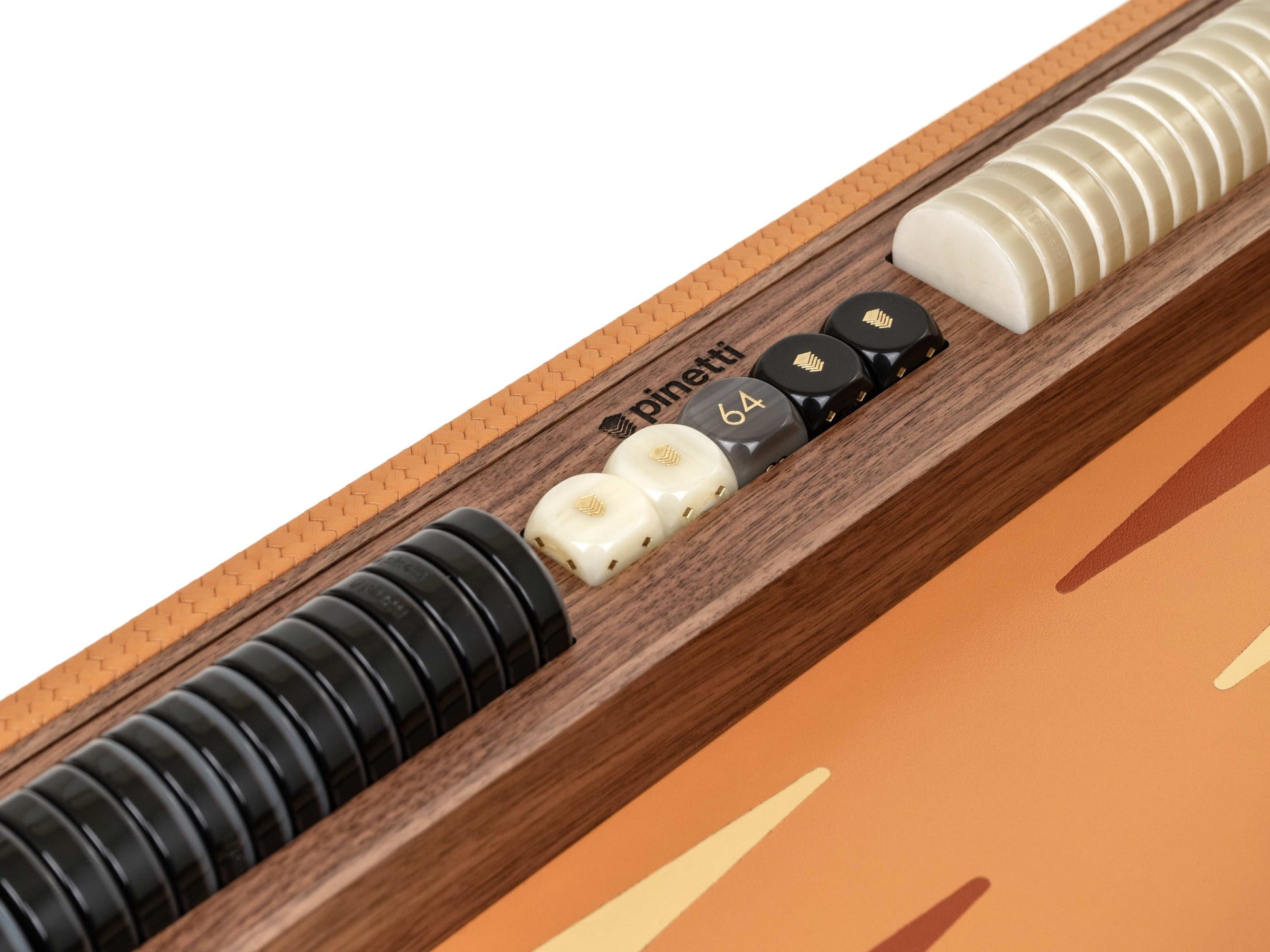 Close-up of a Canaletto walnut backgammon tray with braided leather edge brand logo black checkers ivory pearled pawns and a row of curved ivory discs.