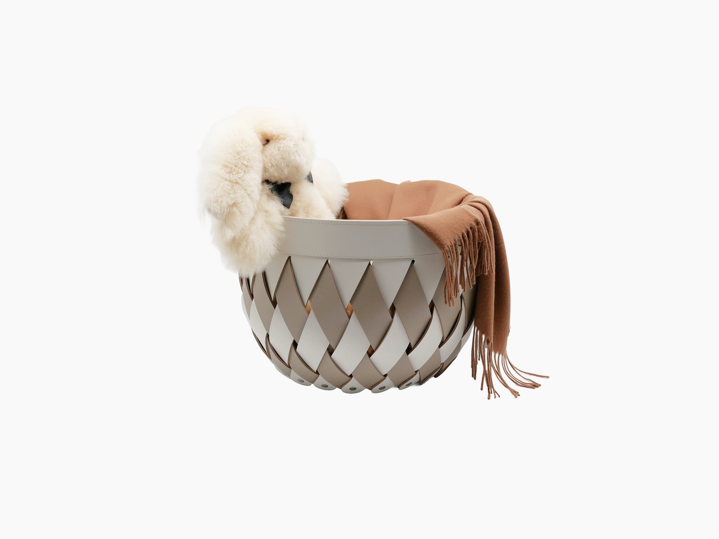 Canaria Small Basket in pale gray braided leather with fluffy white fur and a tan scarf draped over the edge.