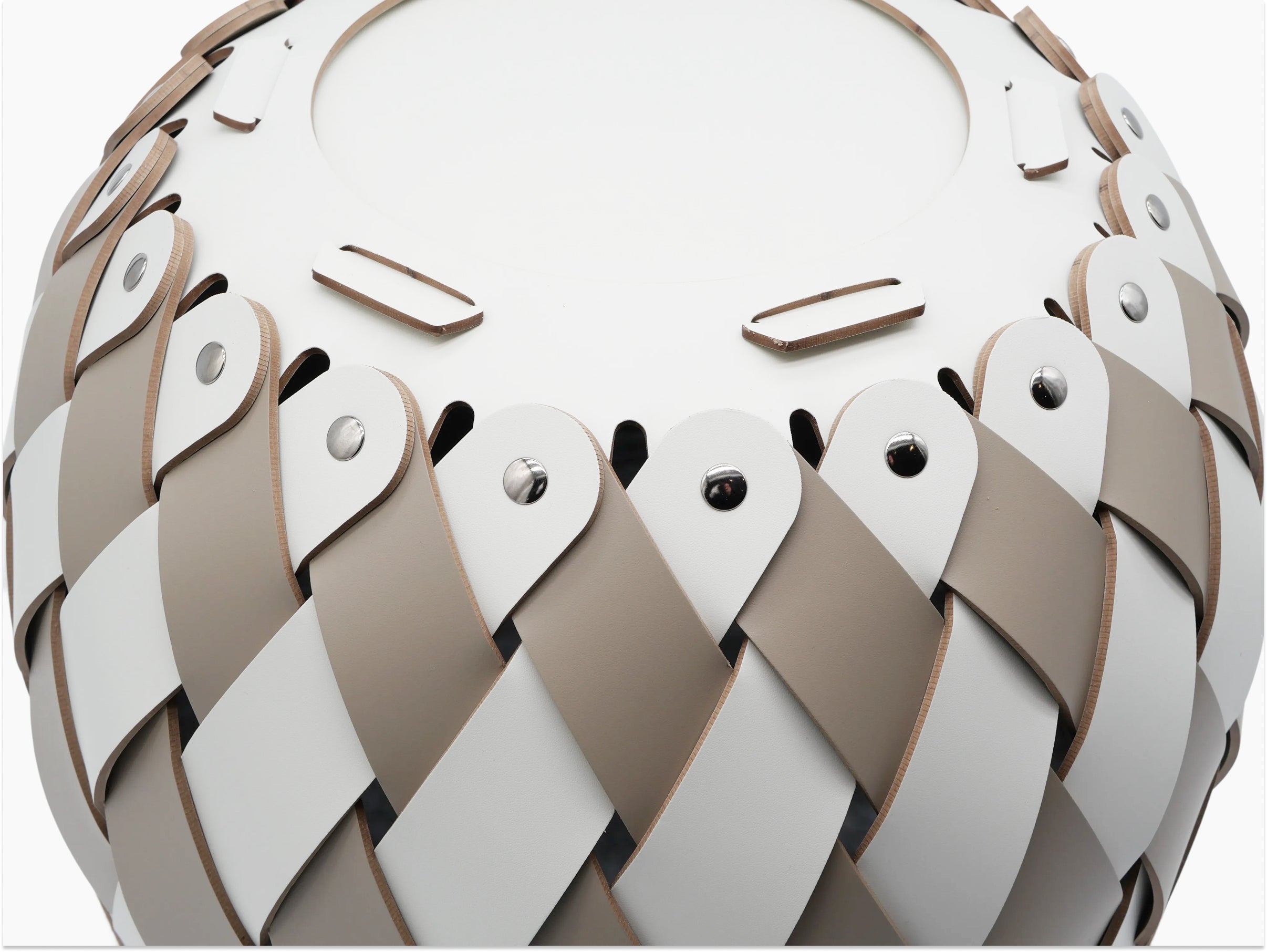 Edge detail of Canaria Small Basket with alternating tan and cream leather strips woven in a diamond pattern