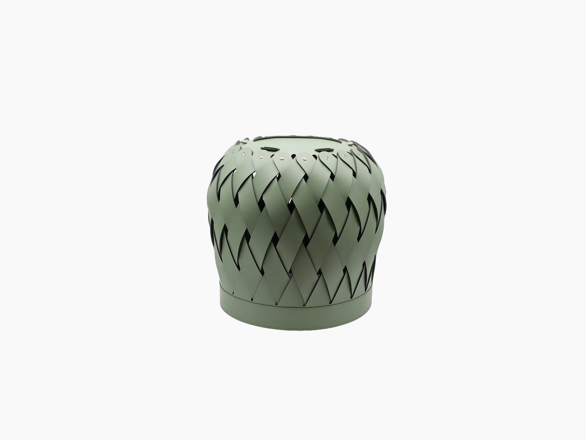 Round Canaria basket with multi tone leather weave, a fluffy bunny peeking over the rim and a beige throw draped over the edge