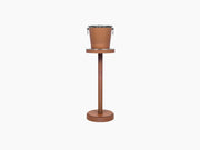 Leather wrapped champagne bucket with metal handles and a bottle inside
